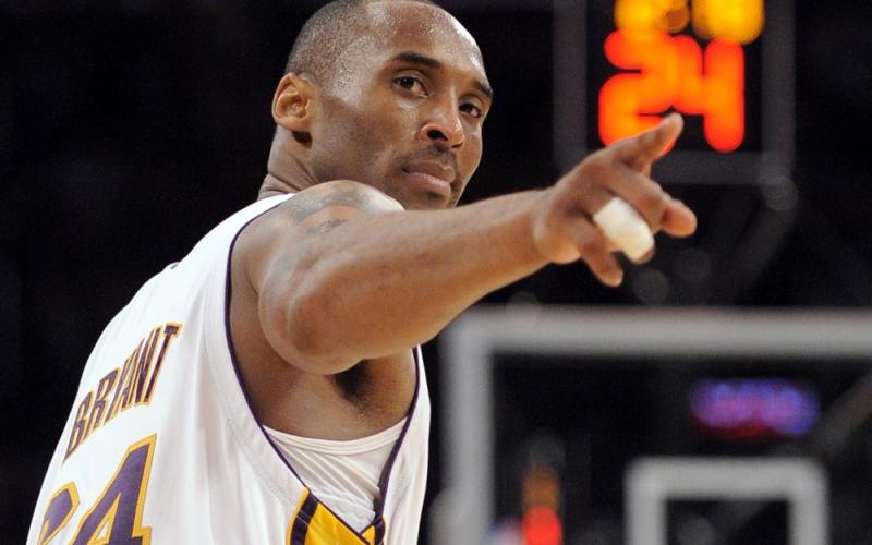 Los Angeles Lakers guard Kobe Bryant (24) points to a player behind him after making a basket in the closing seconds against the Orlando Magic in Game 2 of the NBA basketball finals on June 7, 2009, in Los Angeles. Bryant, the 18-time NBA All-Star who won five championships and became one of the greatest basketball players of his generation during a 20-year career with the Los Angeles Lakers, died in a helicopter crash Sunday. (AP FILE PHOTO)