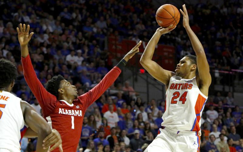 Florida forward Kerry Blackshear Jr. takes a jump shot over Alabama's Herbert Jones (1) during Saturday’s game at the O’Connell Center. (TRIBUNE NEWS SERVICE)