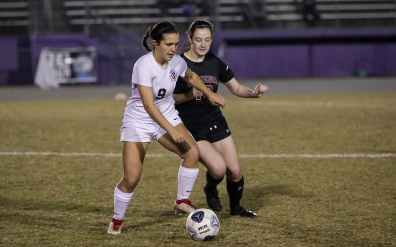 Columbia’s Kirsten Garner fights for possession of the ball with Leon’s Ashley Fink during Monday night’s District 2-6A quarterfinals. (BRENT KUYKENDALL/Lake City Reporter)