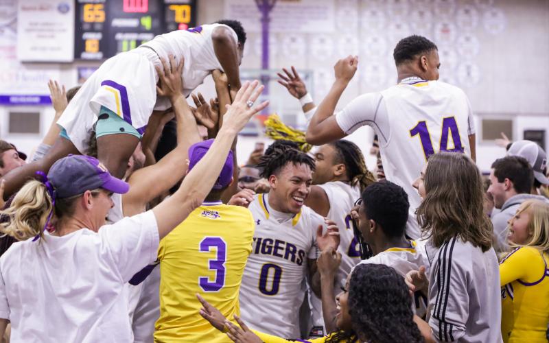 Columbia’s basketball team celebrates with students after defeating Daytona Beach Mainland 70-65 in Friday night’s Region 1-6A final. (BRENT KUYKENDALL/Lake City Reporter)