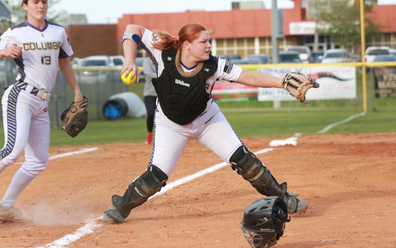 Columbia catcher Reece Chasteen fields a bunt and throws to first base in a game against Middleburg last season. Chasteen, along with third baseman Morgan Hoyle (left) are two of the Lady Tigers’ returning starters this season. (JEN CHASTEEN/Special to the Reporter)