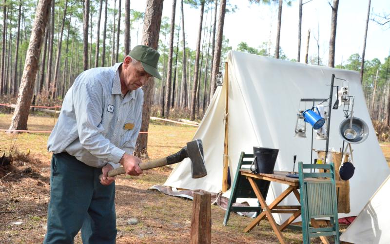 Mark Akers chops firewood at camp. Akers, an artillery coordinator for the Battle of Olustee re-enactment, has been camping at the battlegrounds for several days while he helps to organize one of North Florida’s biggest events. (CARL MCKINNEY/Lake City Reporter)