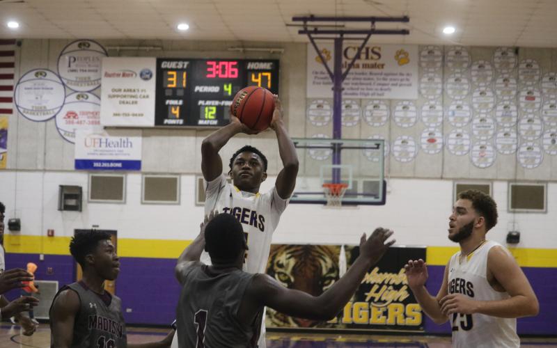 Columbia guard Kenney Gaines pulls up for a shot against Madison County on Friday night. (ZACH ABOLVERDI/Lake City Reporter)