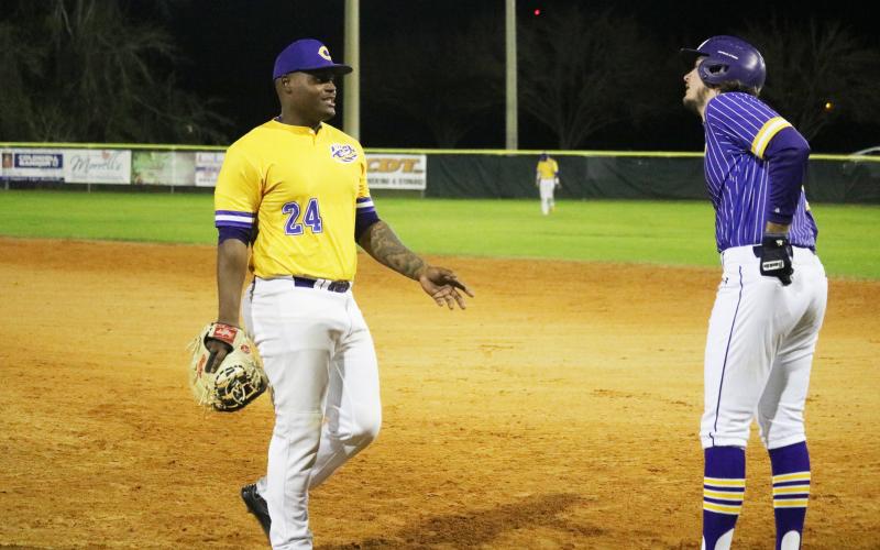 Columbia first baseman Daylon Lumpkin talks to Lance Minson after Minson reached first base safely during the Purple &amp; Gold scrimmage Friday night. (JORDAN KROEGER/Lake City Reporter)
