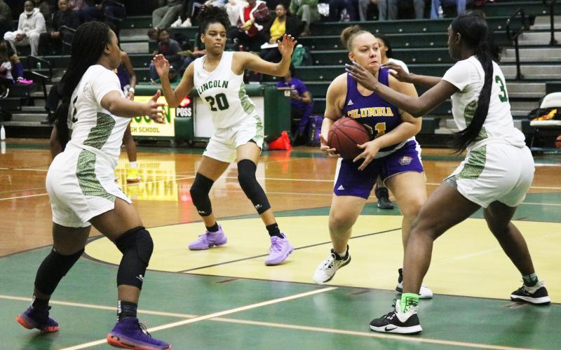 Columbia center Amaiya Callym is surrounded by Lincoln defenders during Saturday night's District 2-6A championship game. (JORDAN KROEGER/Lake City Reporter)
