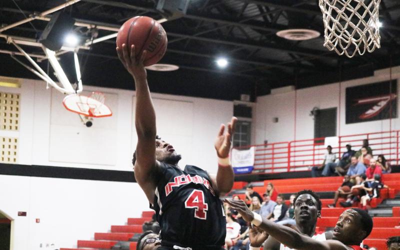 Fort White guard D.J. Mathews goes up for a shot against Hilliard during Tuesday’s District 6-1A semifinals. (ZACH ABOLVERDI/Lake City Reporter)