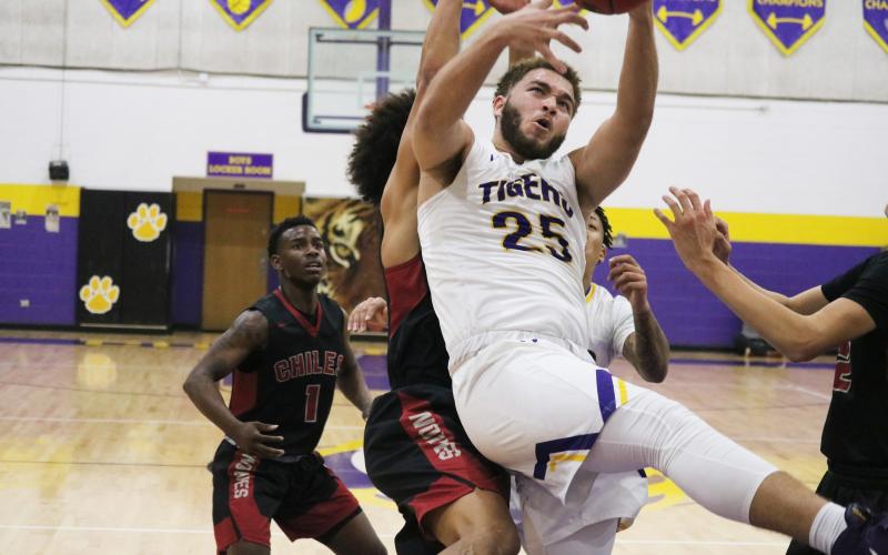 Columbia center Marcus Owens grabs a rebound in traffic against Chiles during Friday’s District 2-6A semifinal. (JORDAN KROEGER/Lake City Reporter)
