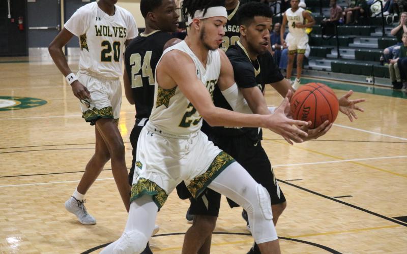 FGC forward Brandon Farmer chases after a loose ball with Pasco-Hernando's Marion Jones III on Saturday. (JORDAN KROEGER/Lake City Reporter)