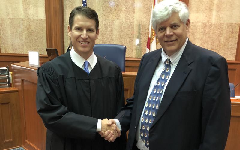Interim Third Circuit State Attorney Dave Phelps shakes hands with Judge Mark Feagle after his swearing in December. (FILE)
