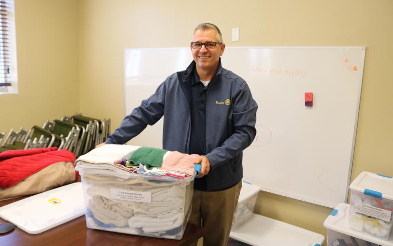 Mike Tatem, Parkview Baptist Church pastor, moves a container of towels and other toiletries on Thursday while preparing to open the church’s cold weather shelter. (TONY BRITT/Lake City Reporter)
