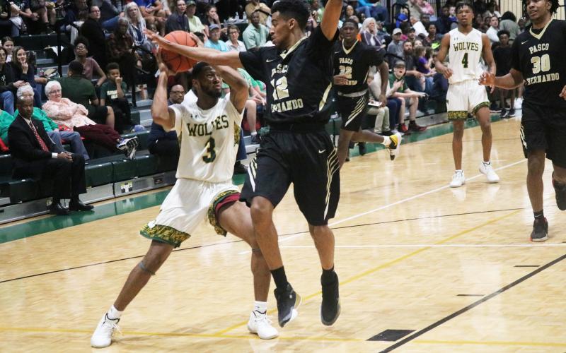 FGC guard Kenny Brown Jr. looks to shoot as Pasco-Hernando's Marion Jones III defends on Saturday. (JORDAN KROEGER/Lake City Reporter)