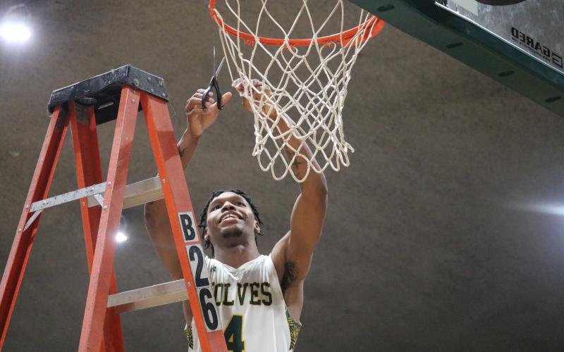 FGC guard Tay Cobb cuts down the nets after defeating Pasco-Hernando State College in the Divison II Region 8 championship on Saturday. (JORDAN KROEGER/Lake City Reporter)