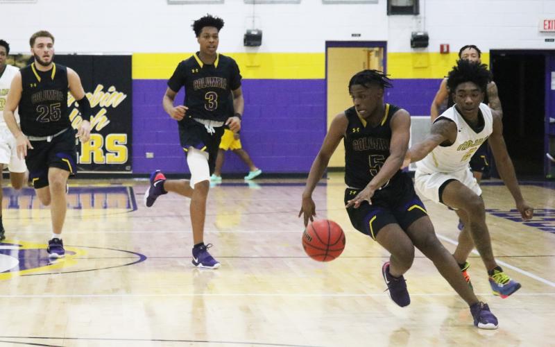 Columbia guard Darrien Jones pushes the ball up the floor against Lincoln Saturday night.  (JORDAN KROEGER/Lake City Reporter)