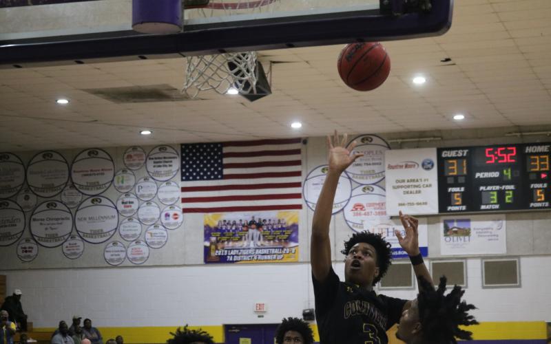 Columbia guard Charleston Ponds puts up a shot against Lincoln Saturday night.  (JORDAN KROEGER/Lake City Reporter)