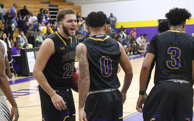 Columbia center Marcus Owens celebrates after guard Jordan Smith made a basket while getting fouled during Saturday night's game against Lincoln.  (JORDAN KROEGER/Lake City Reporter)