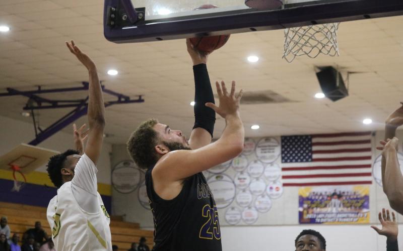 Columbia center Marcus Owens scores a basket against Lincoln Saturday night.  (JORDAN KROEGER/Lake City Reporter)