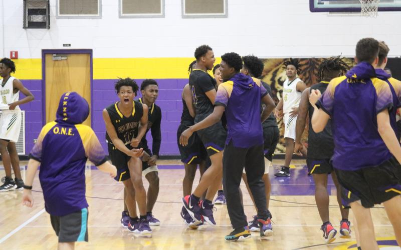Columbia's basketball team celebrates after defeating Lincoln to win the District 2-6A title on Saturday night.  (JORDAN KROEGER/Lake City Reporter)
