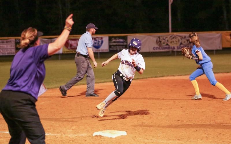 Columbia coach Trudy Andrews waves home Morgan Hoyle as she heads toward third base against Chiefland on March 10. (BRENT KUYKENDALL/Lake City Reporter)