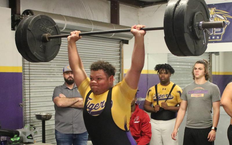 Columbia’s Nate Walsmley finishes his clean and jerk during Wednesday’s meet against Buchholz. Walmsley won the heavyweight class with a 600-pound total. (JORDAN KROEGER/Lake City Reporter)