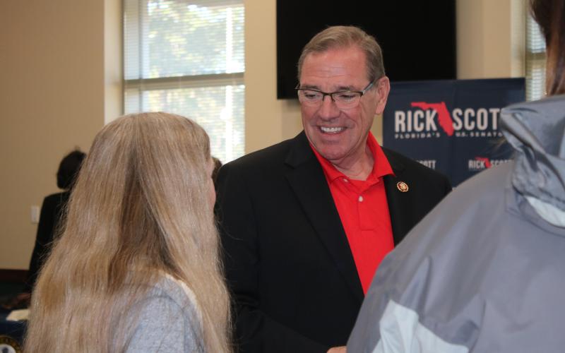 U.S. Rep. Neal Dunn chats with Rebecca Presnell, who, at 14, has already started the process of meeting admission requirements of the U..S Naval Academy. (AMY HIETT/Special to the Reporter)