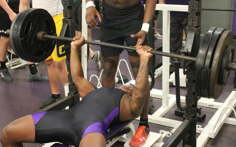 Columbia’s Marlon Pollock bench presses during a meet on March 11. (JORDAN KROEGER/Lake City Reporter)