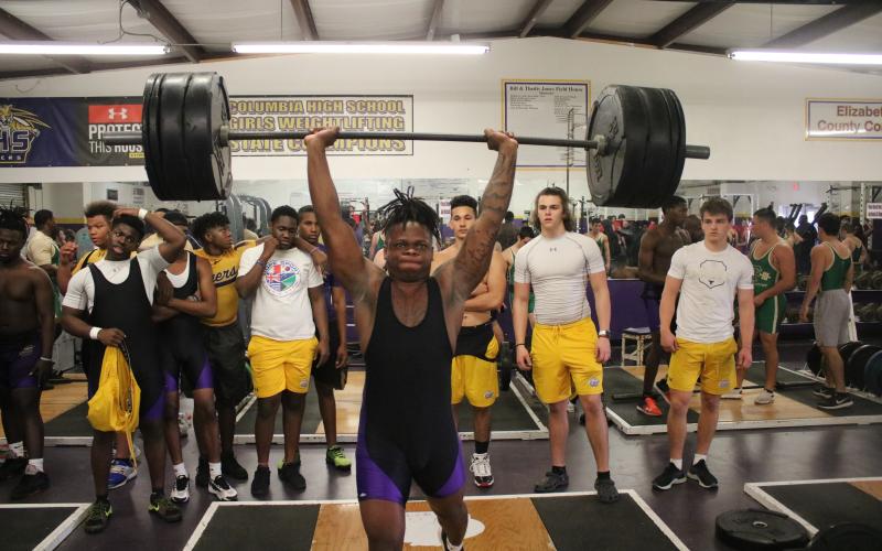 Columbia’s Marlon Pollock performs the clean and jerk during Wednesday’s tri-meet against Fleming Island and Baker County. (JORDAN KROEGER/Lake City Reporter)