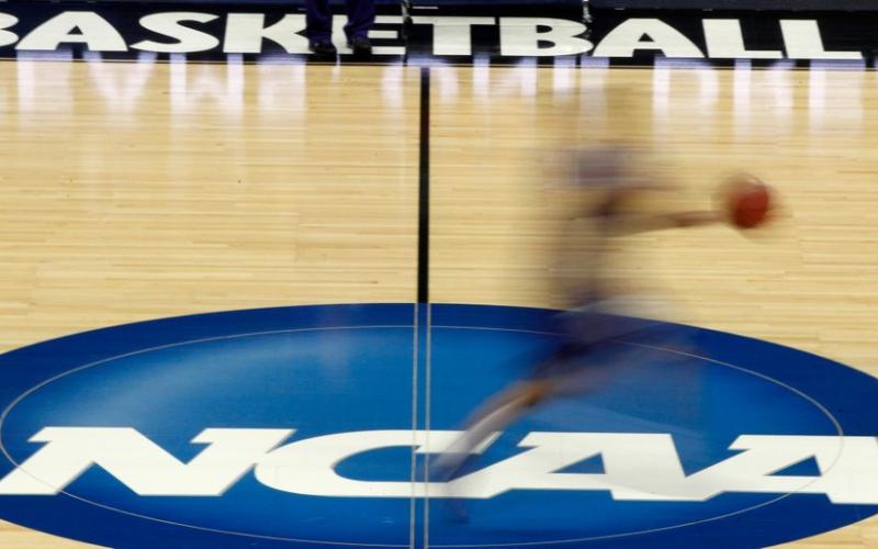 A player runs across the NCAA logo during practice at the NCAA tournament on In this March 14, 2012, in Pittsburgh. (AP FILE PHOTO)