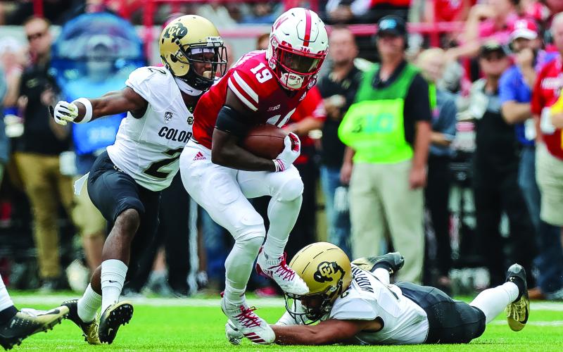 Nebraska Cornhuskers receiver Mike Williams escapes a tackle from Colorado Buffaloes defensive back Evan Worthington while defensive back Ronnie Blackmon attempts to make a tackle at Memorial Stadium on Sept. 8, 2018, in Lincoln, Neb. (MICHAEL SPOMER/Cal Sport Media via AP)