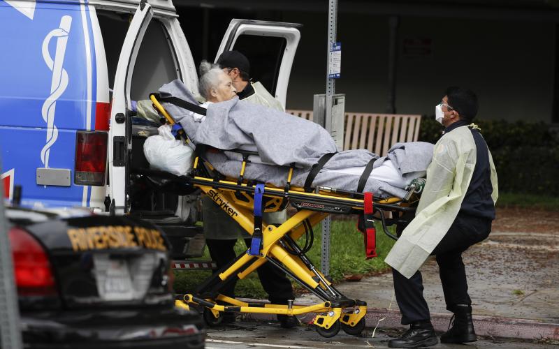 A patient is evacuated from the Magnolia Rehabilitation and Nursing Center in Riverside, Calif., on April 8. More than 80 patients from a Riverside skilled nursing facility are being evacuated this morning to other healthcare locations throughout Riverside County, Calif. (AP PHOTO)