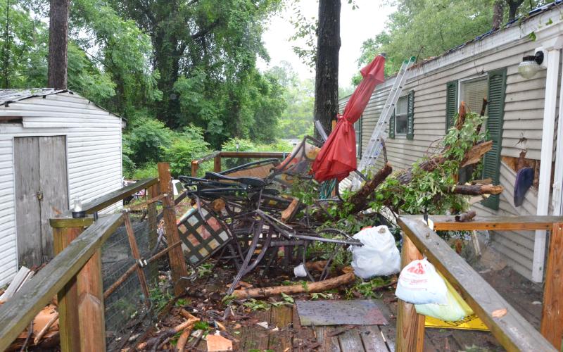 The home of Lenore Camp and an adjacent utility shed came out of the storm with a fair amount of damage, but Camp maintained hope it could be fixed with relative speed. Camp got a weather alert mere seconds before the storm hit. (CARL MCKINNEY/Lake City Reporter)