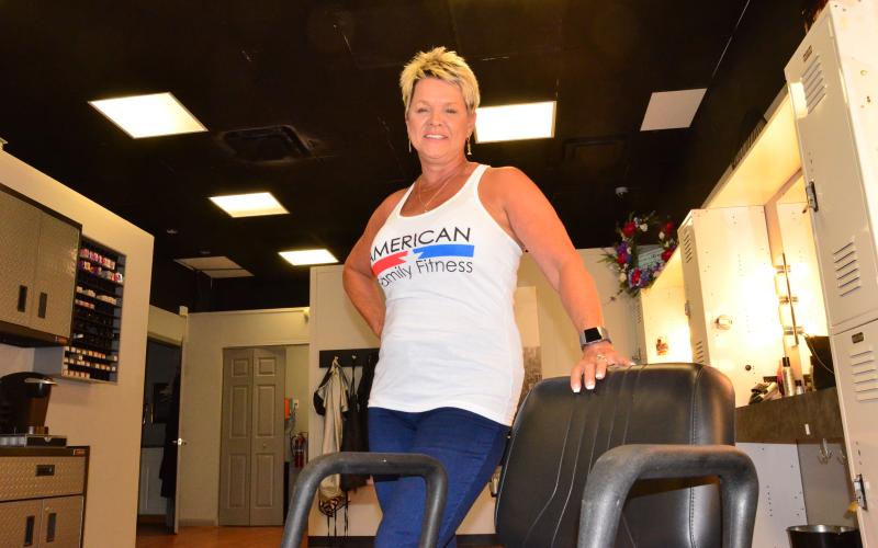 Lisa Waltrip, owner of Haircuts Unlimited in Village Plaza, is seen in her shop Thursday. Despite a state order, she remains open for business, accepting daily appointments for haircuts. (CARL MCKINNEY/Lake City Reporter)