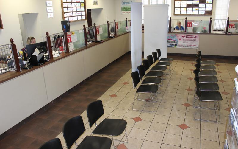 The waiting area of the Columbia County Tax Collector’s office sits vacant at 2 p.m. Wednesday, while a few clerks process paperwork transactions at their work stations. (TODD WILSON/Lake City Reporter)
