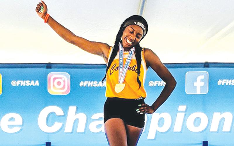 Columbia jumper Asherah Collins celebrates on the podium with her gold medal after winning the Class 3A state title in the triple jump last May at Hodges Stadium at UNF. (FILE)