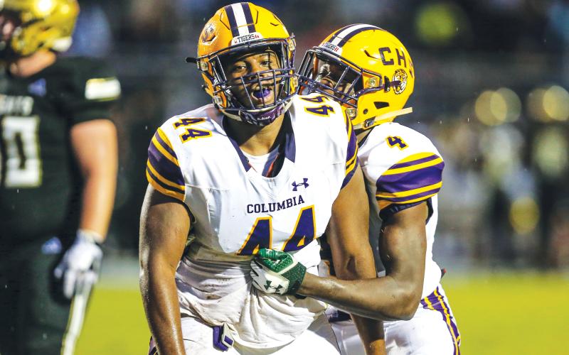 Columbia defensive lineman Terrick Ponds (44) is congratulated by linebacker Le’vontae Camiel (4) after a tackle for loss against Oakleaf on Aug. 30, 2019. (FILE)