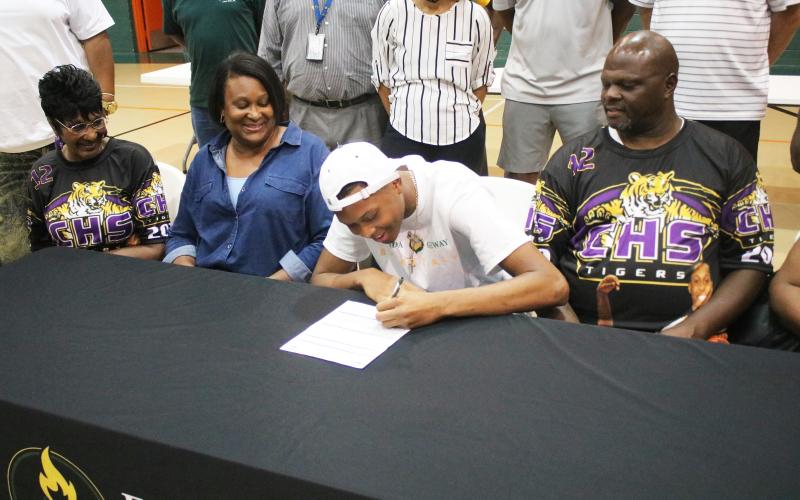 Columbia forward D’Andre Jefferson signs his letter of intent to play at Florida Gateway College on Friday. (JORDAN KROEGER/Lake City Reporter)