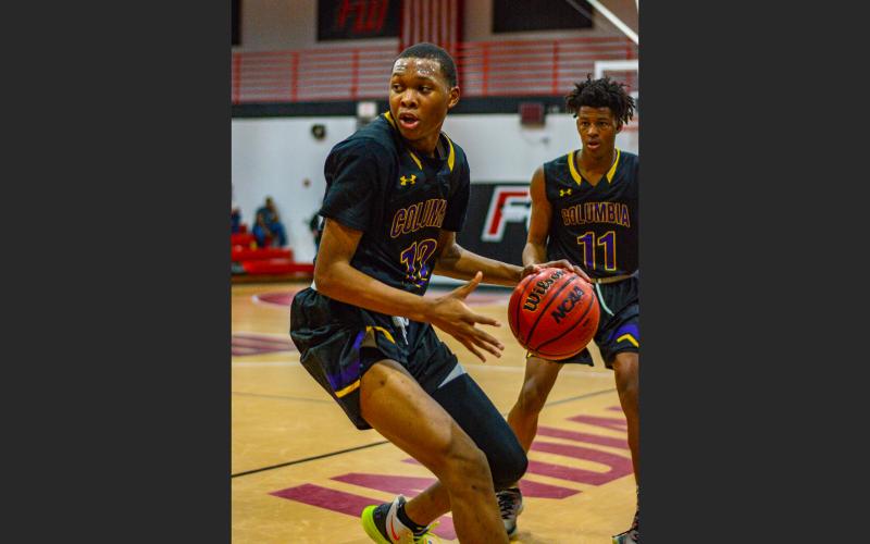 Columbia forward D’Andre Jefferson turns to drive to the basket against Fort White on Dec. 13, 2019. (THOMAS RICKS/Special to the Reporter)