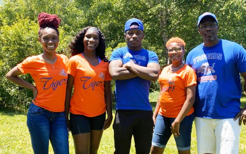 Columbia track &amp; field athlete Tracy White (middle) is pictured with his family all decked out in Savannah State apparel. White recently signed his national letter of intent with the Tigers. (COURTESY)