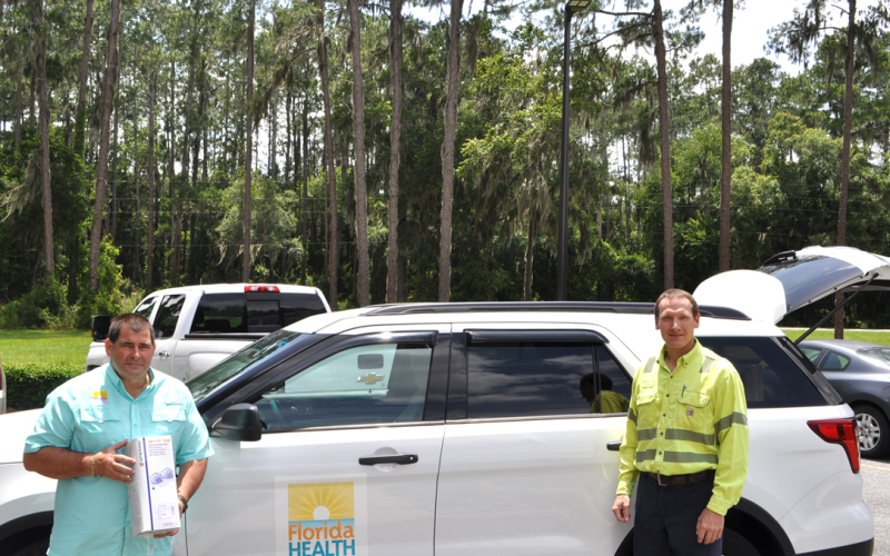 Tom Moffses, administrator, Columbia/Hamilton Health Department, left, is seen with William Ponton, general manager, Nutrien-White Springs. In the car are a total of 10,200 masks, a gift from Nutrien to the local DOH. (COURTESY)