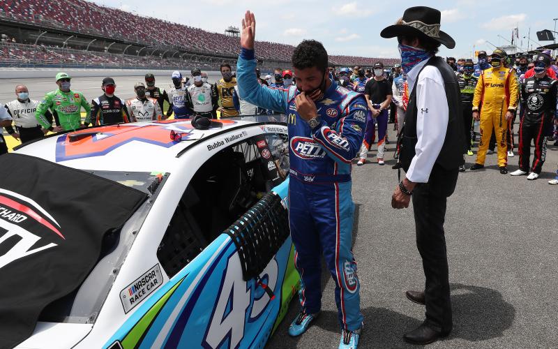 Bubba Wallace, driver of the #43 Victory Junction Chevrolet, and NASCAR Hall of Famer and team owner Richard Petty look on after NASCAR drivers pushed Wallace to the front of the grid as a sign of solidarity with the driver prior to the NASCAR Cup Series GEICO 500 at Talladega Superspeedway on Monday in Talladega, Ala. (CHRIS GRAYTHEN/Getty Images/TNS)