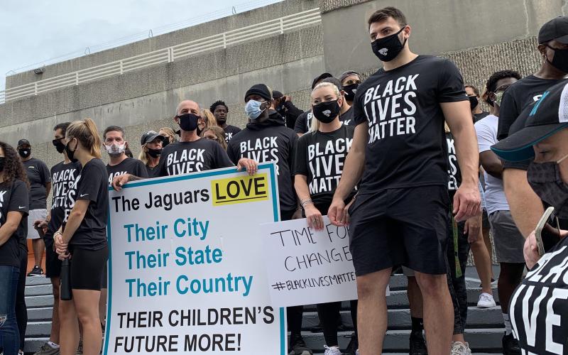 Members of the Jaguars organization, including rookie tight end Tyler Davis (right) stand on the steps of the Jacksonville Sheriff's Office during a peaceful protest on Friday. (TRIBUNE NEWS SERVICE)