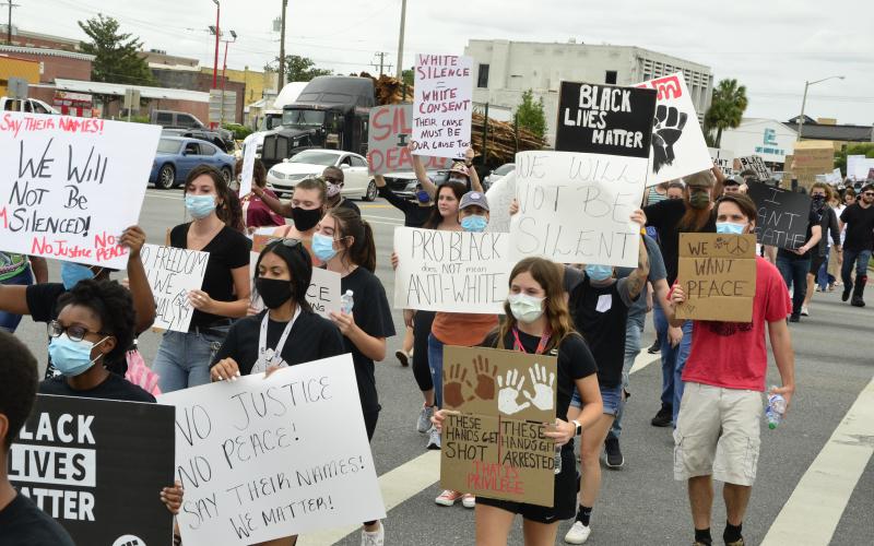 Protesters chant “no justice, no peace” as they march along U.S. 90. The march ended a little after 3 p.m. Friday. (CARL MCKINNEY/Lake City Reporter)