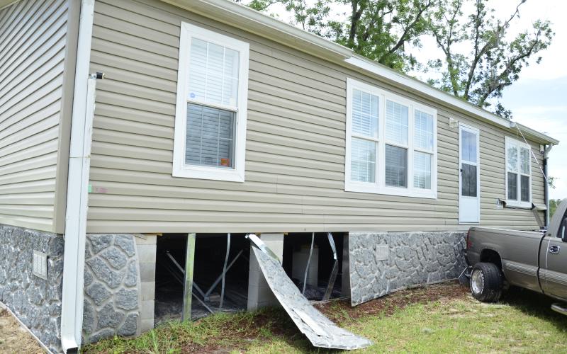 Some of the skirting on this home was torn off by the tornado, but the damage was relatively minimal compared to what could have happened, the owner said. (CARL MCKINNEY/Lake City Reporter)
