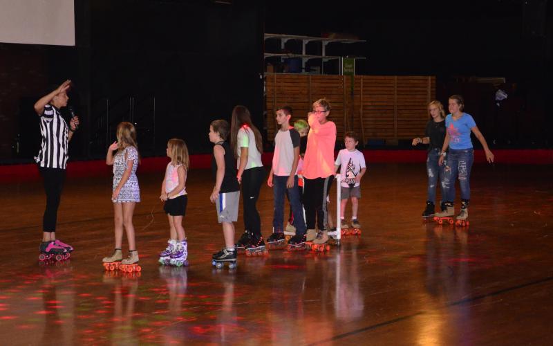Skaters play a game of limbo at the rink. (CARL MCKINNEY/Lake City Reporter)