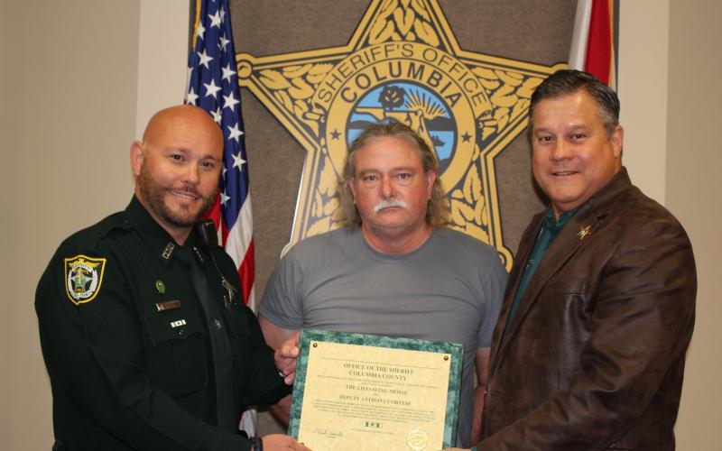 Deputy Anthony Cortese, left, is seen with Jim Osburn and Sheriff Mark Hunter. (COURTESY)