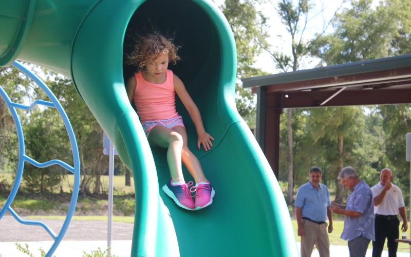 Sailor Hunter, 4, has a ‘hair-raising’ experience as she takes a ride down the sliding board Friday morning at the Columbia City Park. The park, which is fully compliant with the American Disabilities Act, is the county’s first fully inclusive playground. (TONY BRITT/Lake City Reporter)