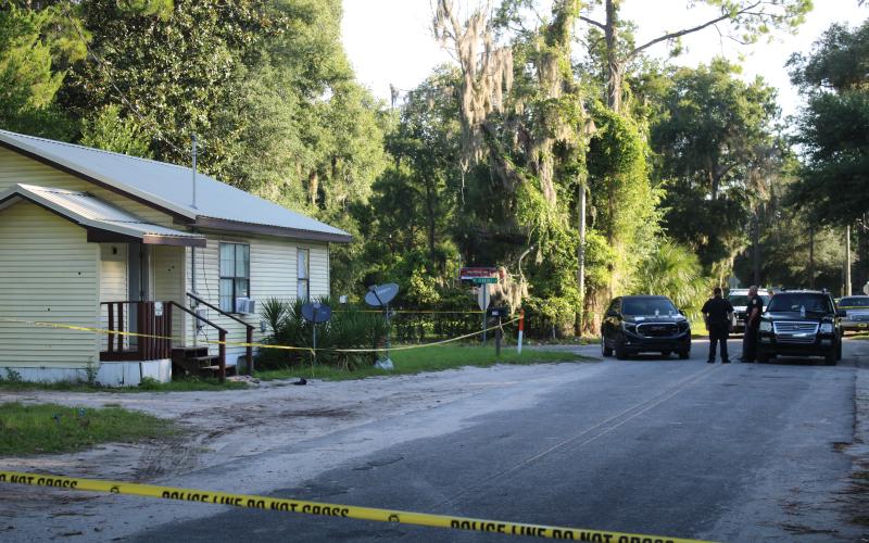 The house on NE Webster Avenue was cordoned off Tuesday morning as authorities searched for evidence. A Lake City police officer was shot in the overnight hours while doing a well-being check. (TONY BRITT/Lake City Reporter)