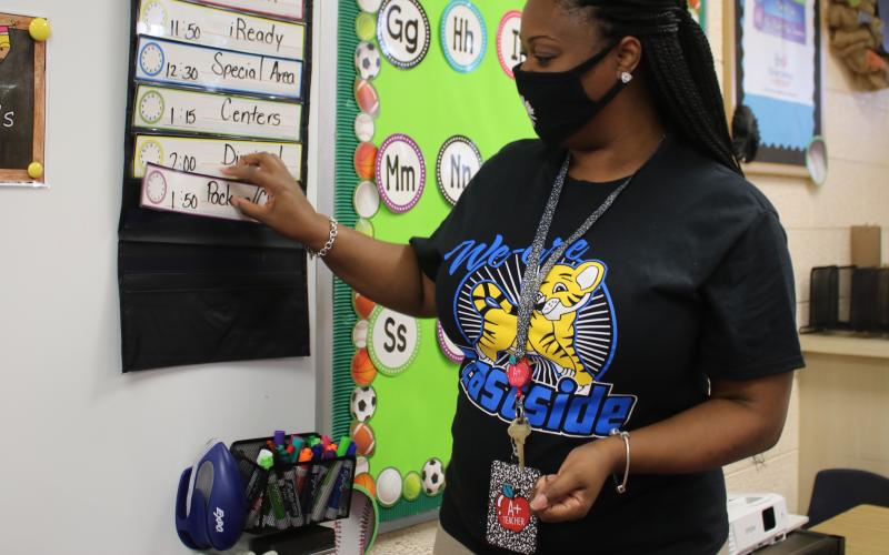 Karla Rodriguez, an Eastside Elementary School kindergarten teacher, places classroom schedules in packets as she prepares her classroom for the beginning of school on Monday morning. (TONY BRITT/Lake City Reporter)