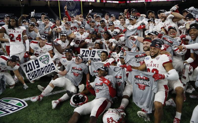 Members of the Miami of Ohio team pose on the field after winning the Mid-American Conference championship against Central Michigan on Dec. 7, 2019, in Detroit. The Mid-American Conference on Saturday became the first league competing at college football’s highest level to cancel its fall season because of covid-19 concerns. (AP FILE PHOTO)