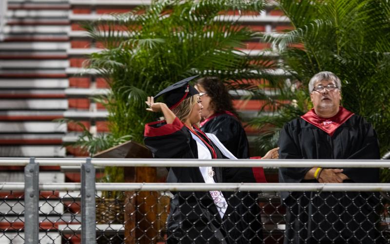 A Fort White senior is excited to receive her diploma during the commencement ceremony. (RAY CARPENTER/Lake City Reporter)