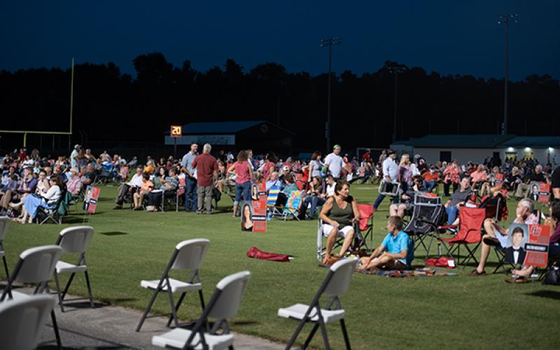 Parents and family members mingle in socially distanced groupings Friday before the Fort White graduation ceremony began. (RAY CARPENTER/Lake City Reporter)